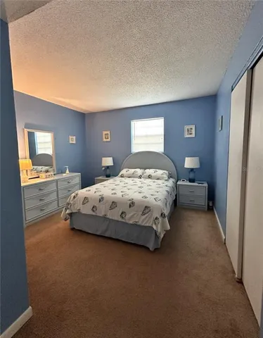 a bedroom with a bed and a lamp with window