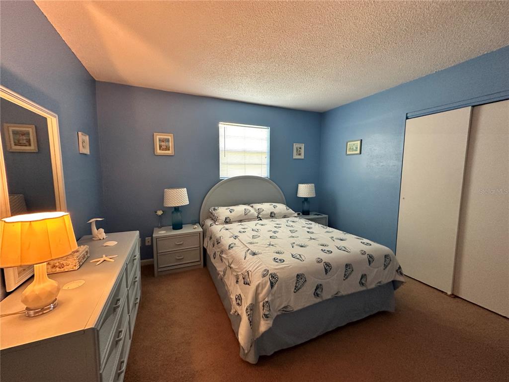 220 South 26th Street, Unit 3 Flagler Beach, FL 32136 - Photo 10 of 20 a bedroom with a bed and wooden floor