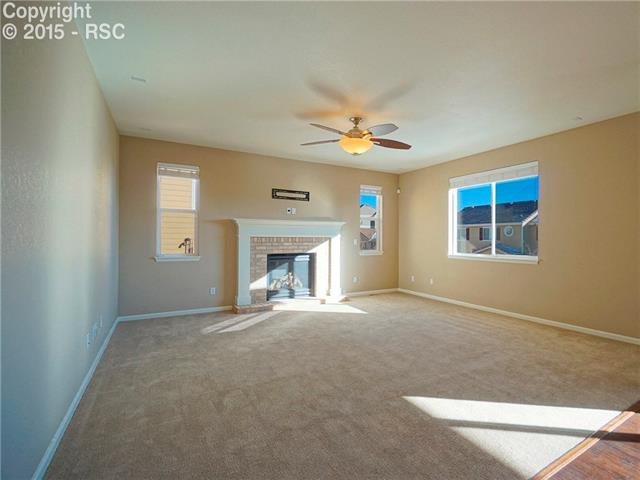 1474 Diamond Rim Drive Colorado Springs, CO 80921 - Photo 7 of 17 Living room with gas fireplace and TV mount ready.