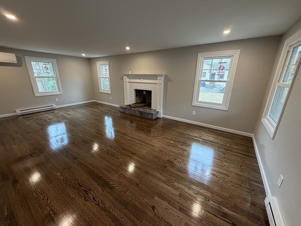 42 Gregory Lane West Springfield, MA 01089 - Photo 2 of 2 an empty room with windows and fireplace