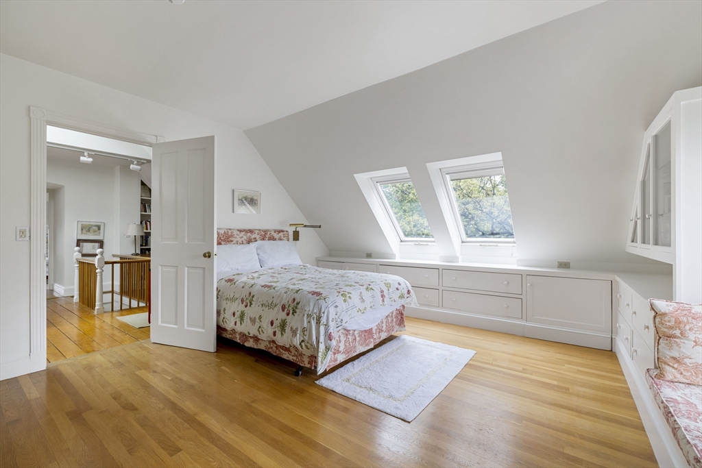 14 Linnaean Street Cambridge, MA 02138 - Photo 11 of 13 a bedroom with a large bed and a wooden floor
