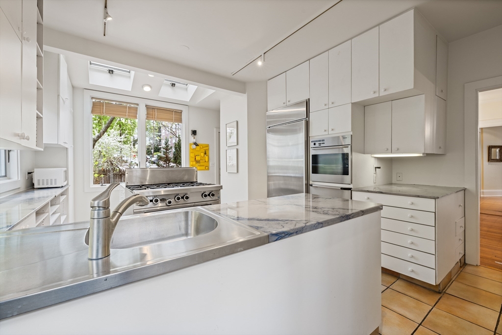 14 Linnaean Street Cambridge, MA 02138 - Photo 3 of 13 a kitchen with stainless steel appliances granite countertop a sink stove and cabinets