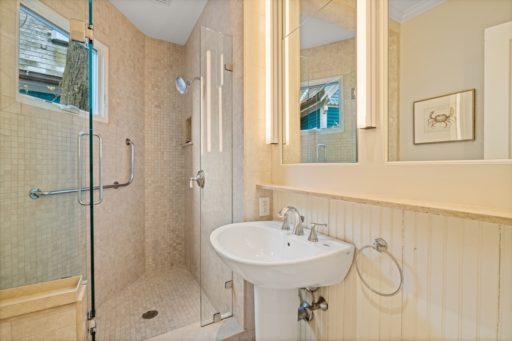 14 Linnaean Street Cambridge, MA 02138 - Photo 7 of 13 a bathroom with a sink a mirror and a shower