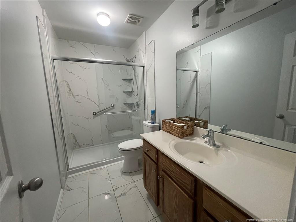 2239 Gray Goose Loop Fayetteville, NC 28306 - Photo 17 of 26 a bathroom with a sink toilet and shower