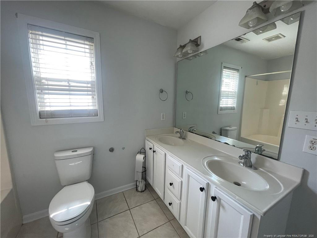 2239 Gray Goose Loop Fayetteville, NC 28306 - Photo 19 of 26 a bathroom with a toilet sink and mirror