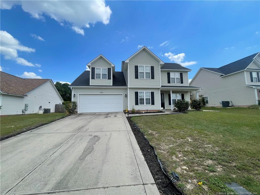 2239 Gray Goose Loop Fayetteville, NC 28306 - Photo 2 of 26 a front view of a house with a yard
