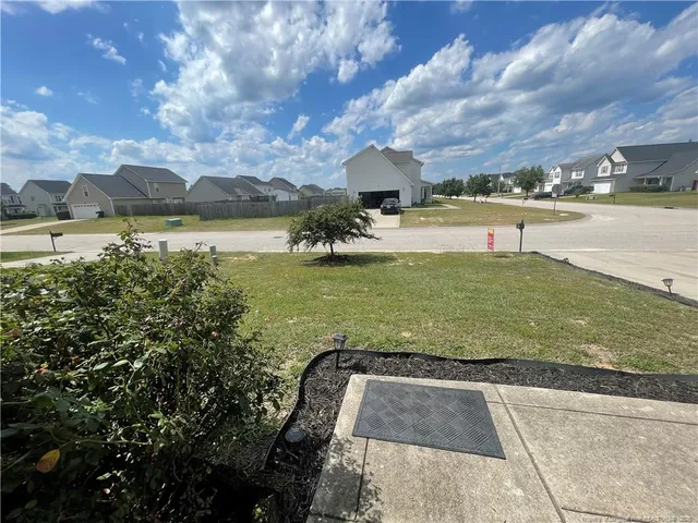 a view of a water fountain and a big yard