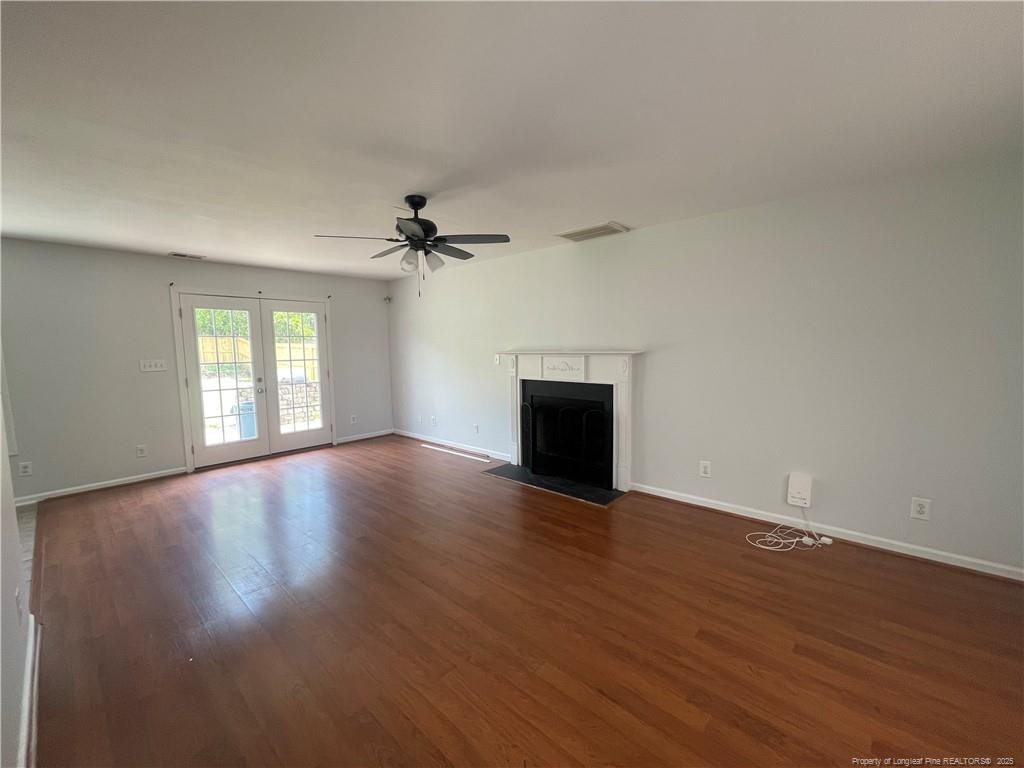 2239 Gray Goose Loop Fayetteville, NC 28306 - Photo 4 of 26 a view of empty room with wooden floor and fireplace