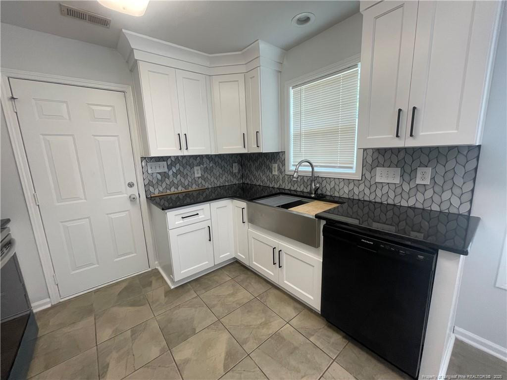 2239 Gray Goose Loop Fayetteville, NC 28306 - Photo 7 of 26 a kitchen with a stove sink and cabinets