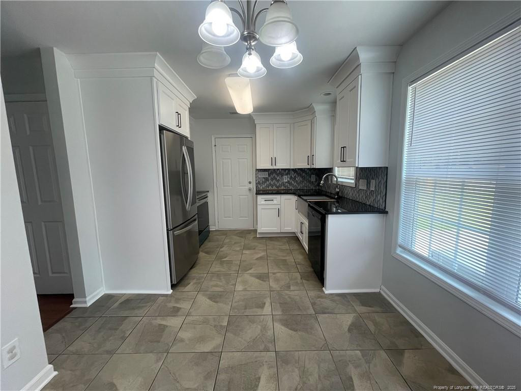 2239 Gray Goose Loop Fayetteville, NC 28306 - Photo 8 of 26 a kitchen with stainless steel appliances granite countertop a refrigerator a sink and dishwasher