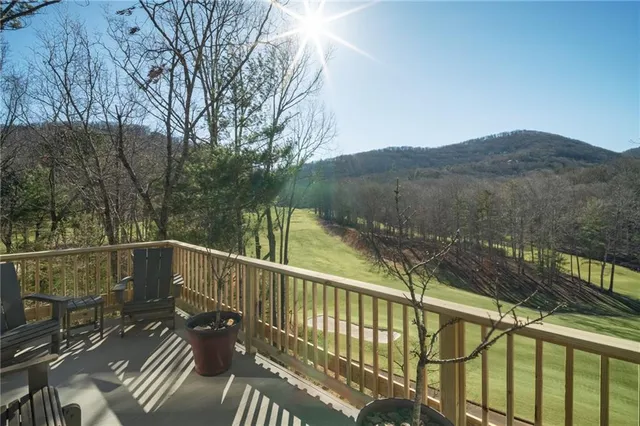 a view of a balcony with wooden floor and fence