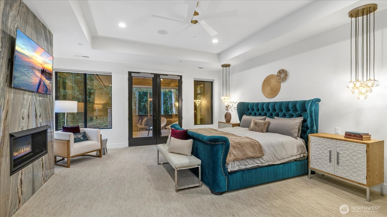 29657 Northeast 52nd Street Carnation, WA 98014 - Photo 30 of 40 a bedroom with a large bed and a fireplace