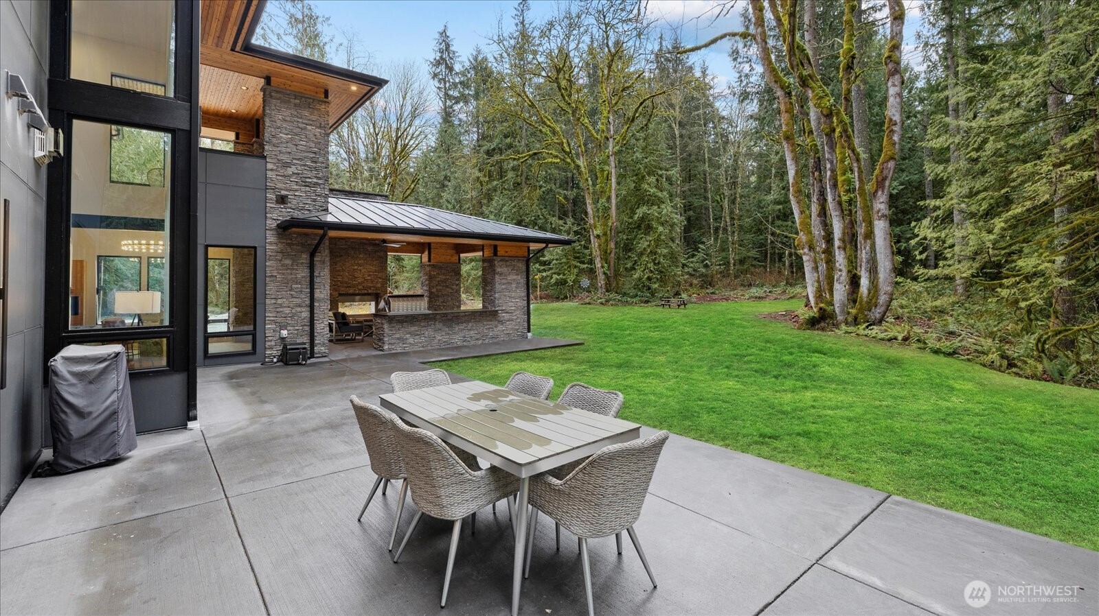 29657 Northeast 52nd Street Carnation, WA 98014 - Photo 36 of 40 a view of a patio with table and chairs and floor to ceiling window