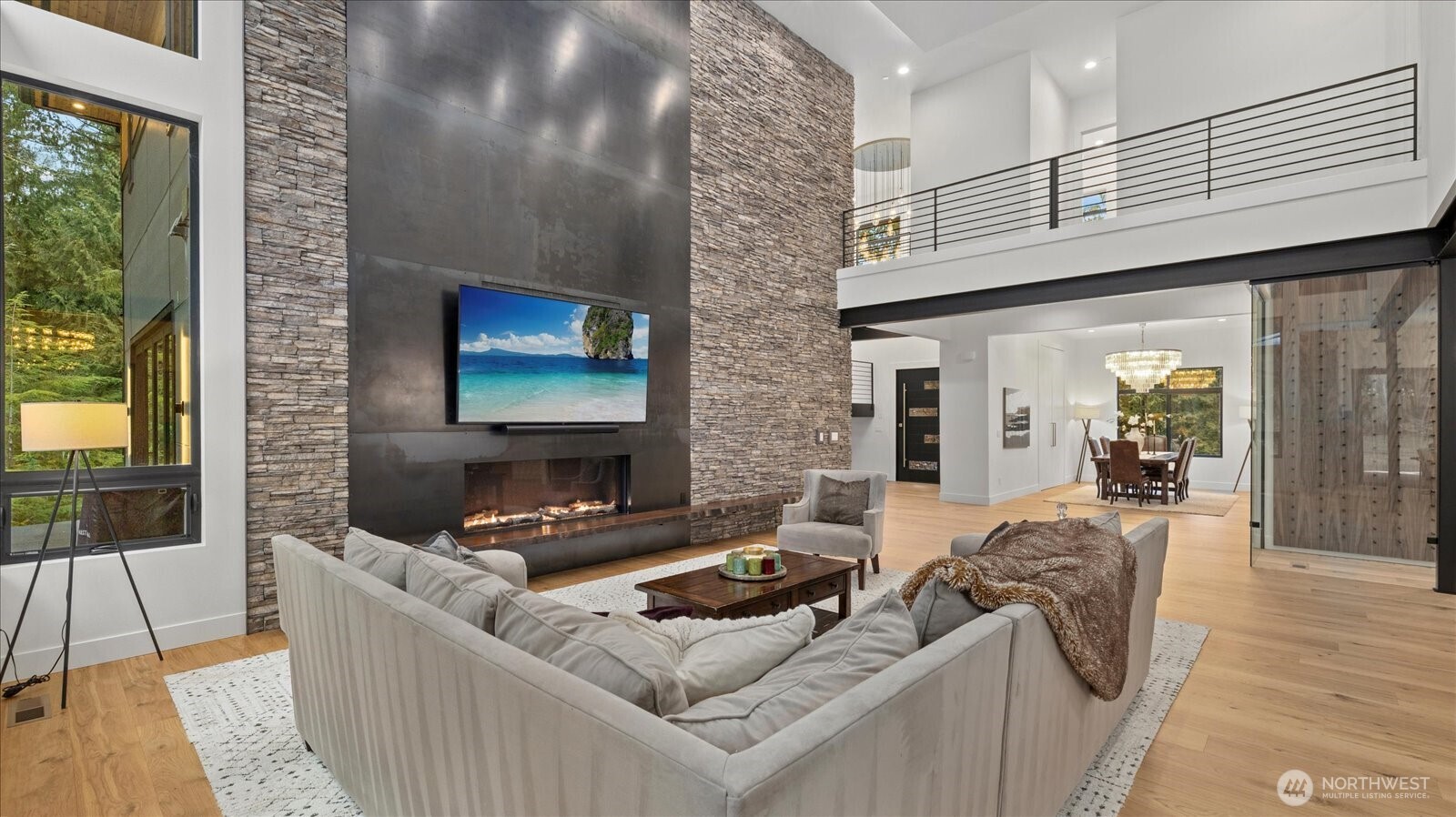 29657 Northeast 52nd Street Carnation, WA 98014 - Photo 9 of 40 a living room with furniture a flat screen tv and floor to ceiling windows