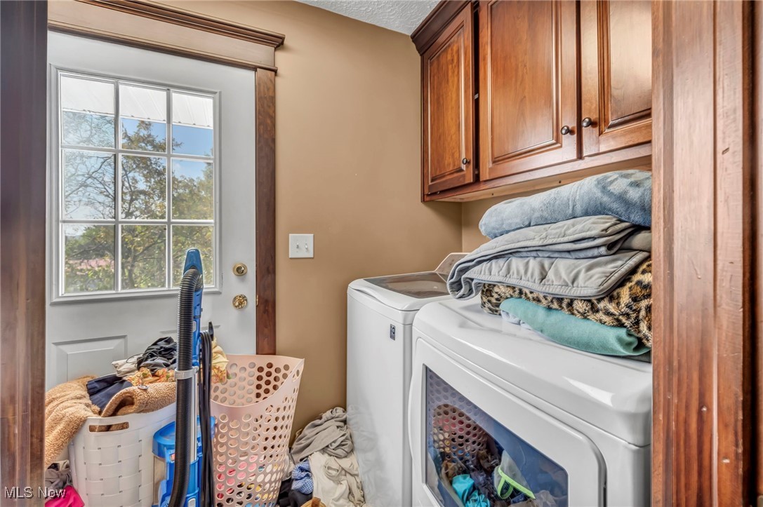 9827 Akron Road Rittman, OH 44270 - Photo 23 of 47 Washroom featuring cabinet space and washer and clothes dryer