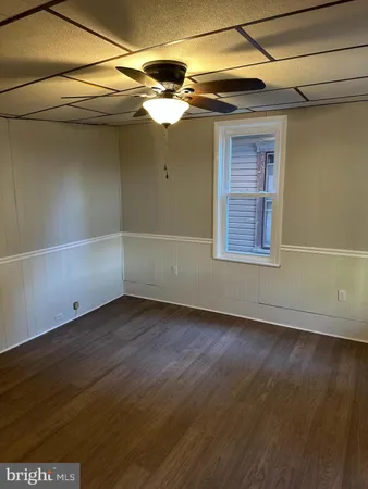 a view of a small space with wooden floor and a window