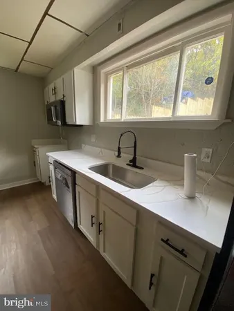 a kitchen with a sink cabinets and window