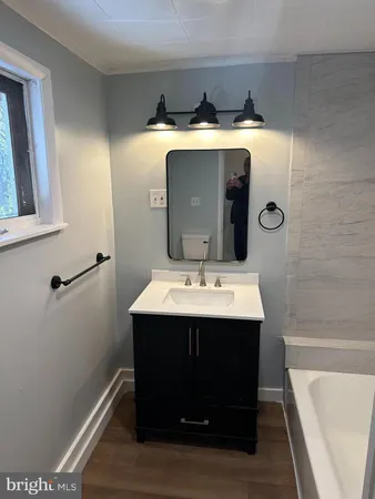 a room with wooden floor and mirror
