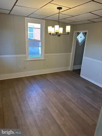 a view of a livingroom with wooden floor and window