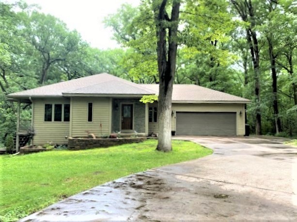 2110 Grand Detour Road Dixon, IL 61021 - Photo 1 of 21 a front view of a house with a garden and trees