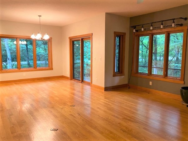 2110 Grand Detour Road Dixon, IL 61021 - Photo 15 of 21 a view of an empty room with glass door and wooden floor