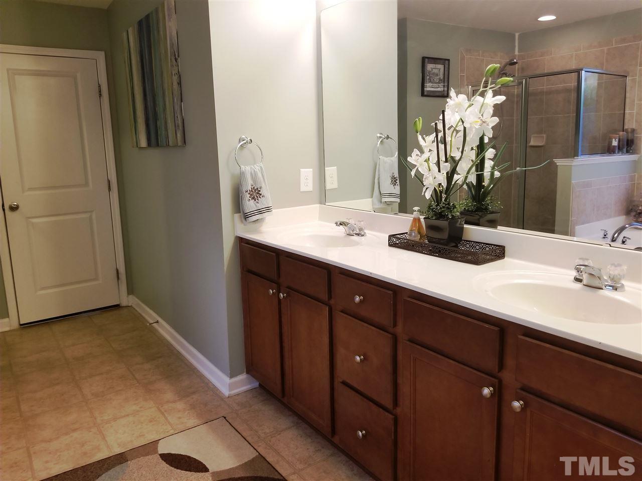 607 Hope Valley Road Knightdale, NC 27545 - Photo 14 of 23 a bathroom with a double vanity sink and mirror