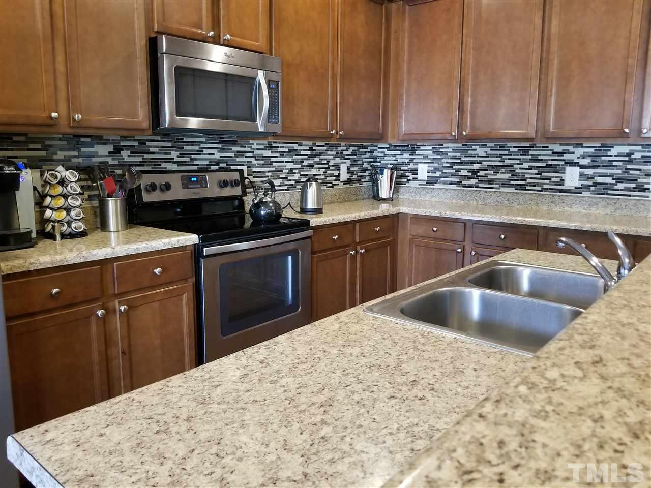 607 Hope Valley Road Knightdale, NC 27545 - Photo 8 of 23 a kitchen with a sink stove and cabinets