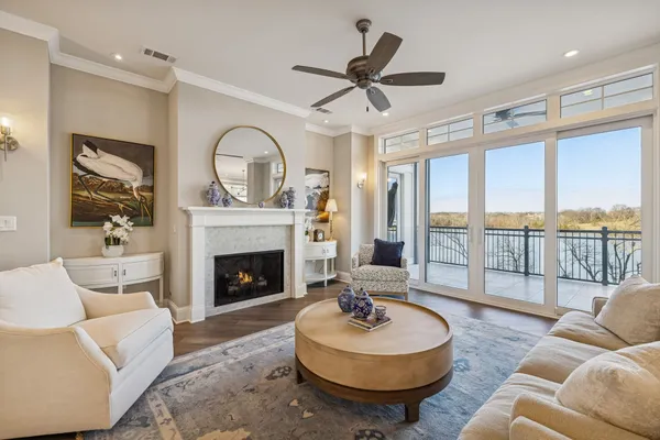 a living room with furniture a fireplace and a large window