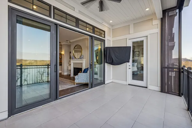 a kitchen with stainless steel appliances granite countertop a sink a stove a refrigerator and island with wooden floor