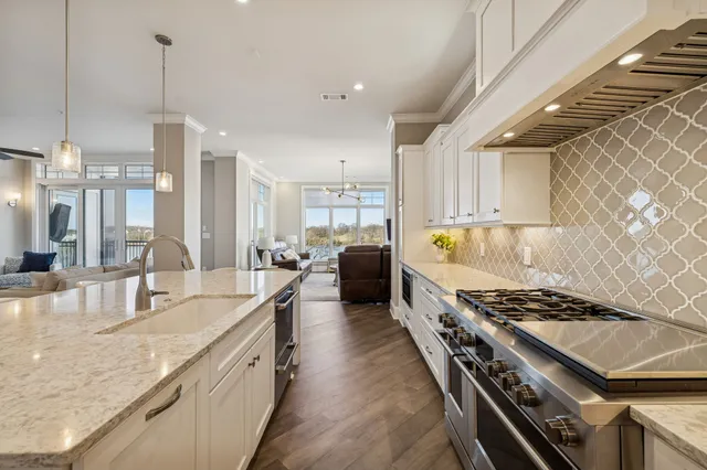 a bathroom with a granite countertop double vanity sink a mirror and a shower