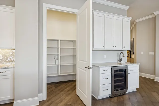 a spacious bathroom with a granite countertop sink mirror and a shower