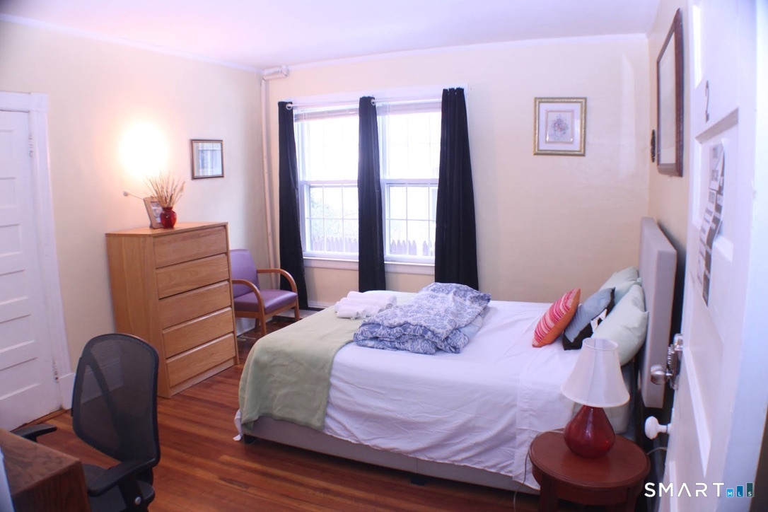 150 Whitney Street Hartford, CT 06105 - Photo 26 of 39 a bedroom with a bed and chair