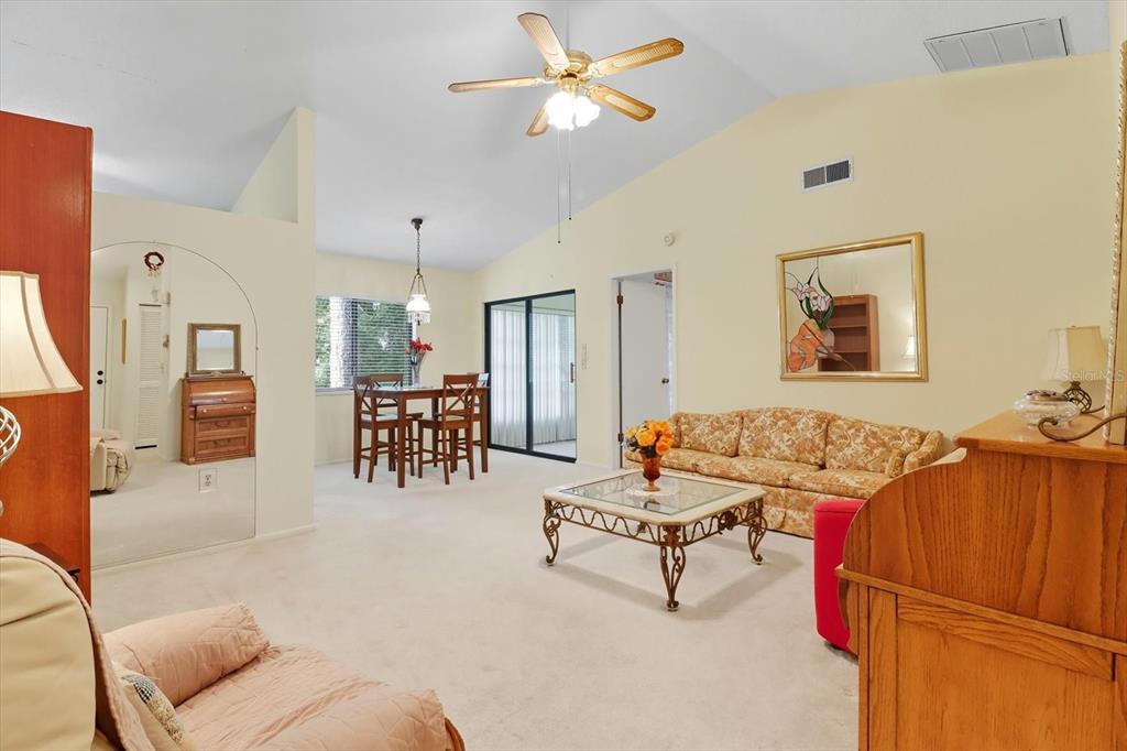 9470 Nakoma Way Weeki Wachee, FL 34613 - Photo 5 of 45 a living room with furniture and kitchen view