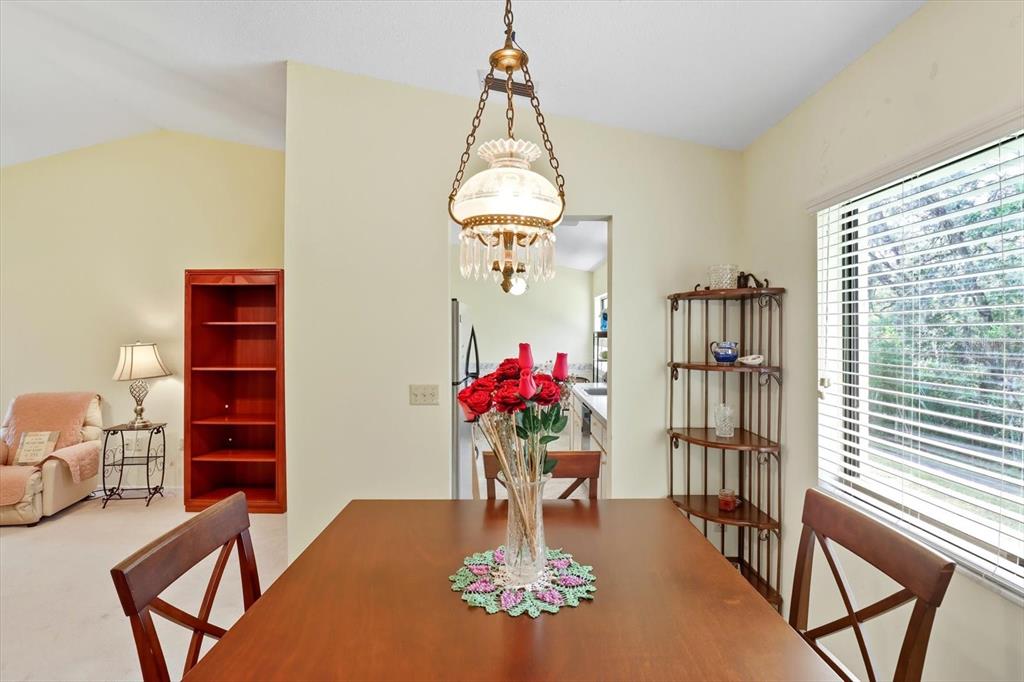 9470 Nakoma Way Weeki Wachee, FL 34613 - Photo 10 of 45 a dining room with chandelier and wooden floor