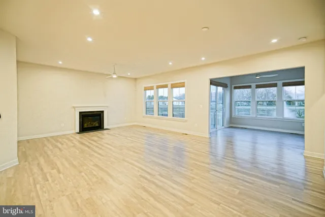 a living room with furniture a fireplace and a large window