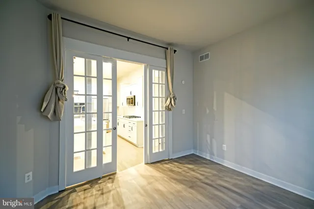 a view of wooden floor and windows in a room