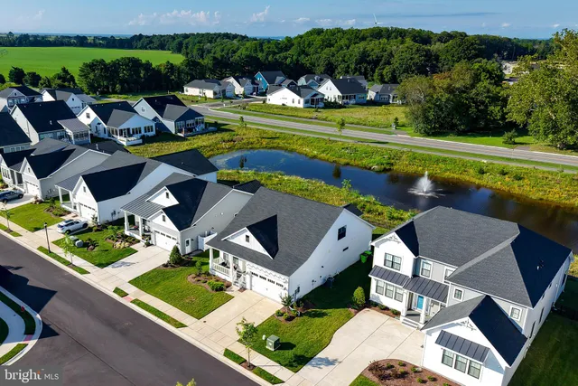 an aerial view of a house with swimming pool patio and outdoor seating