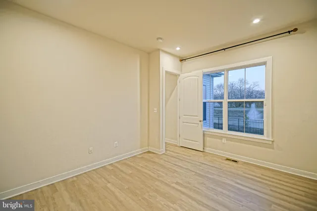 a bedroom with bed and a night stand