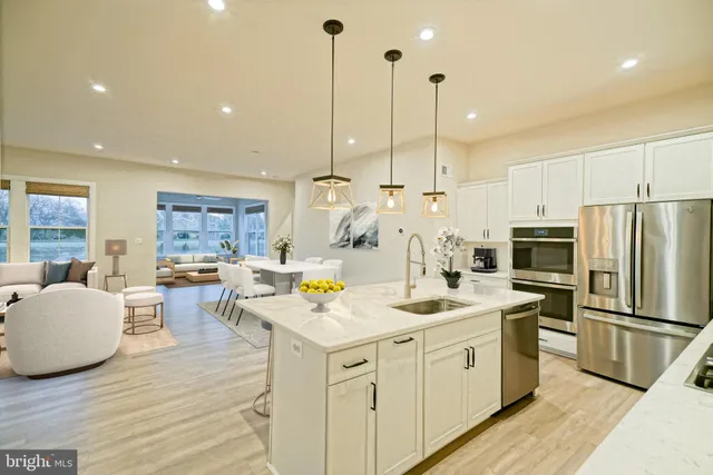 a kitchen with a sink a counter top appliances and cabinets
