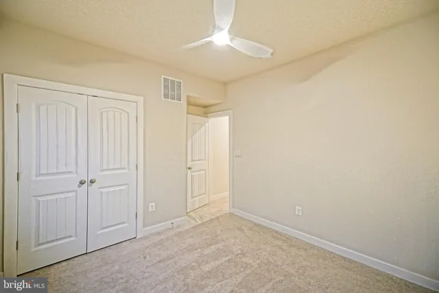 an empty room with closet area