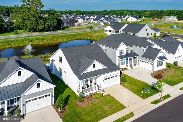 an aerial view of a house with a garden and lake view