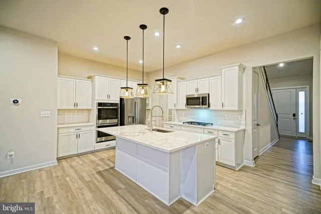 a kitchen with stainless steel appliances a refrigerator and cabinets