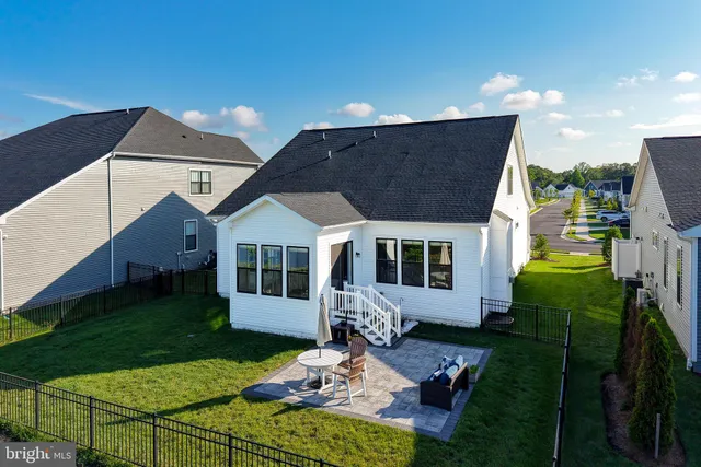 an aerial view of a house with a garden and lake view