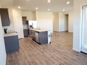 a large kitchen with a large counter top appliances and cabinets