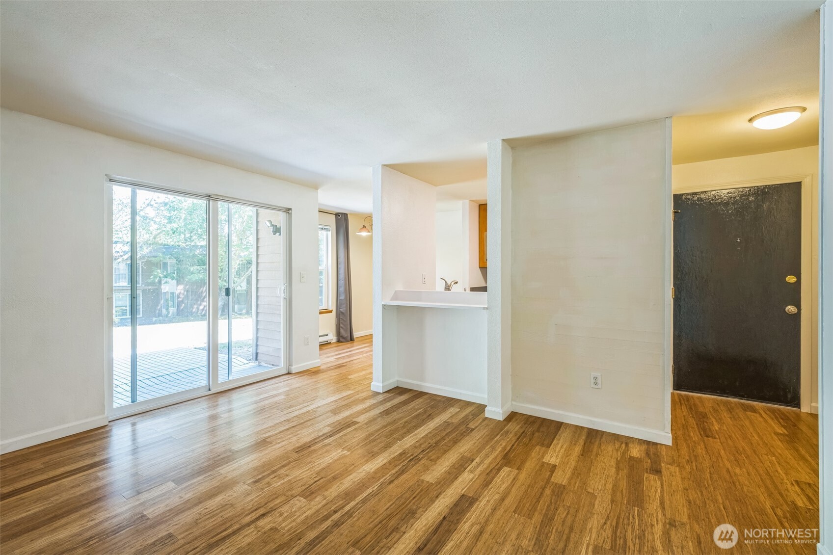 7311 224th Street Southwest, Unit C5 Edmonds, WA 98026 - Photo 5 of 28 a view of an empty room with wooden floor and a window