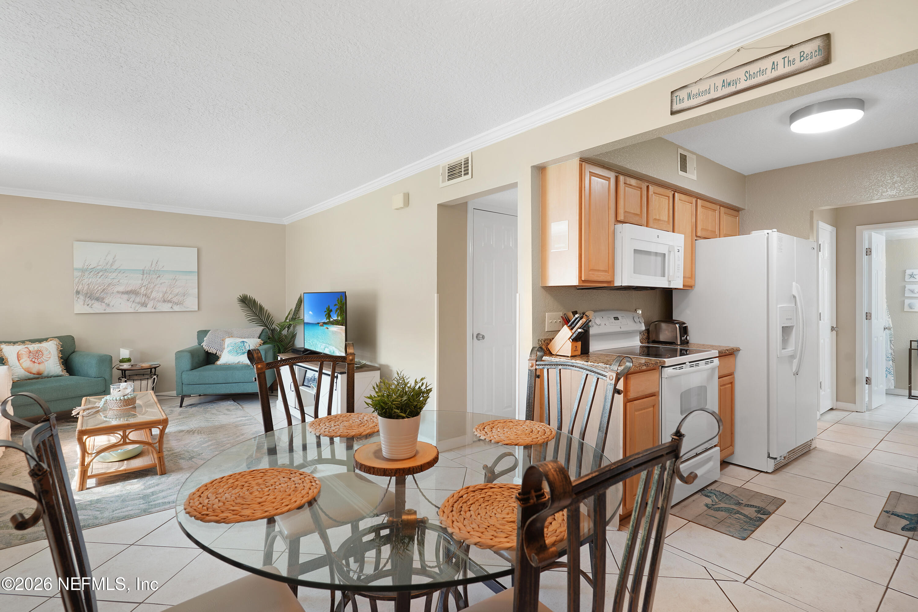 9 Clipper Court St. Augustine, FL 32080 - Photo 7 of 22 a kitchen with stainless steel appliances kitchen island granite countertop a dining table chairs and a refrigerator