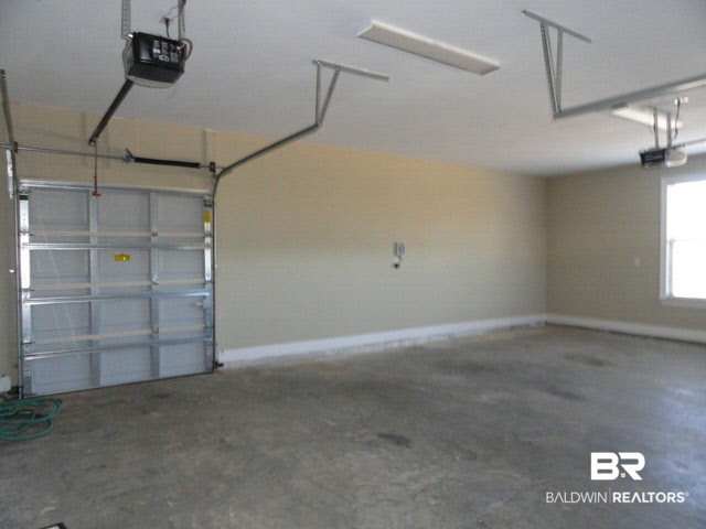 32122 Weatherly Cove Daphne, AL 36527 - Photo 24 of 26 Back of Garage Wall with Door for ATV, Motorcycle, Lawnmower etc.