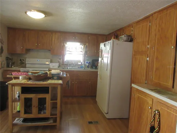a view of a room with furniture and wooden floor
