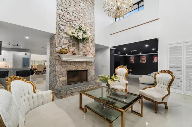 a kitchen with stainless steel appliances granite countertop a sink a stove and a refrigerator