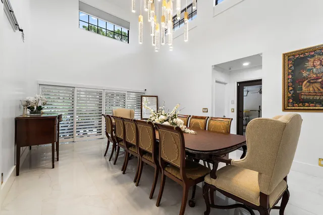 a kitchen with granite countertop kitchen island stainless steel appliances a refrigerator a stove a sink counter space and chairs